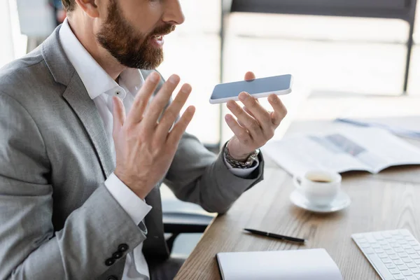 Cropped view of businessman recording voice message on smartphone — Stock Photo