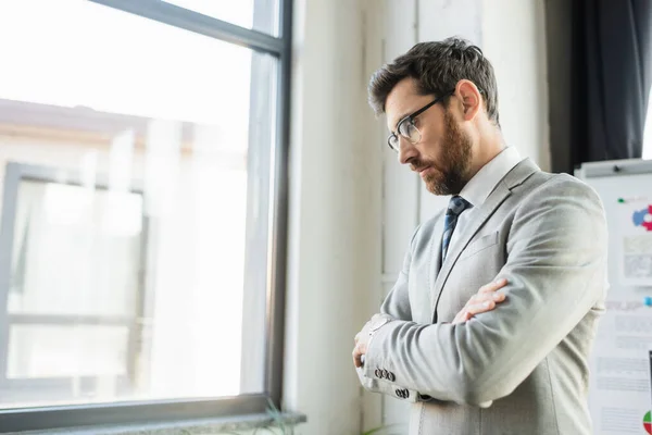 Upset businessman in suit standing in office — Stock Photo