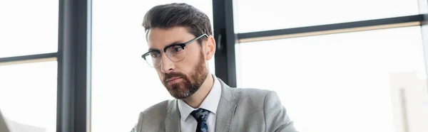 Bearded manager in suit working in office, banner — Stock Photo