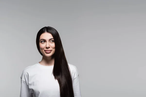 Cheerful woman with straight long hair isolated on grey — Stock Photo