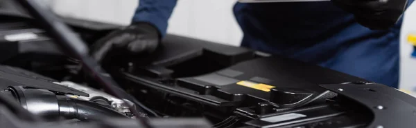 Cropped view of blurred mechanic making diagnostics of car engine, banner — Stock Photo