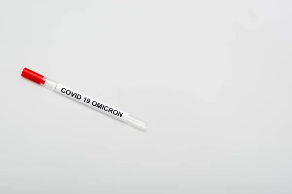 Top view of covid-19 omicron test tube on grey background with copy space - foto de stock