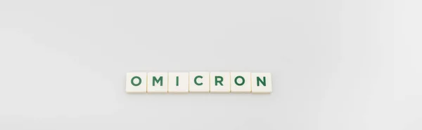Top view of white cubes with omicron lettering on grey background, banner — Photo de stock