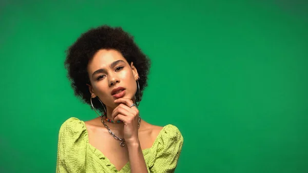 Thoughtful african american woman isolated on green — Stock Photo