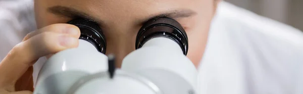 Ophthalmologist working with autorefractor on blurred foreground, banner — Stock Photo