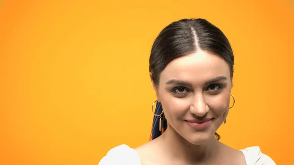 Cheerful woman in blouse looking at camera isolated on yellow — Stock Photo