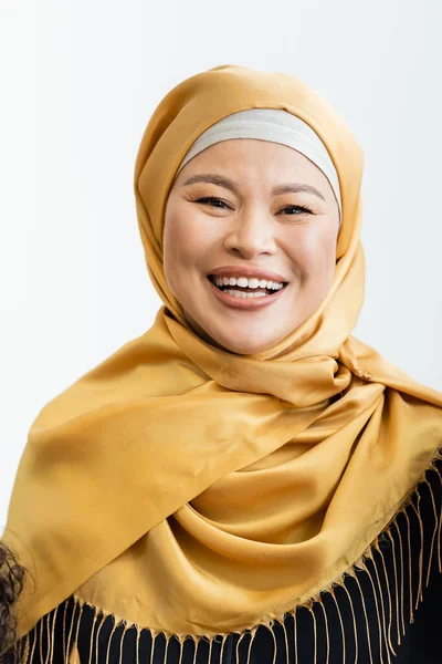Feliz asiático musulmán mujer en hijab sonriendo a cámara aislado en blanco - foto de stock