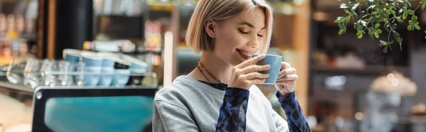 Cheerful woman holding cup of coffee in cafe, banner — Stock Photo