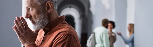 Middle aged teacher looking away in university corridor, banner — Stock Photo