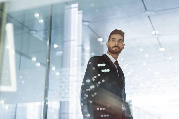 Low angle view of confident bi-racial guard in hotel lobby on blurred foreground — Stock Photo