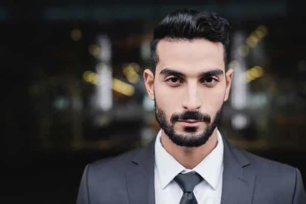 Confident bi-racial guard in formal wear looking at camera outdoors — Stock Photo