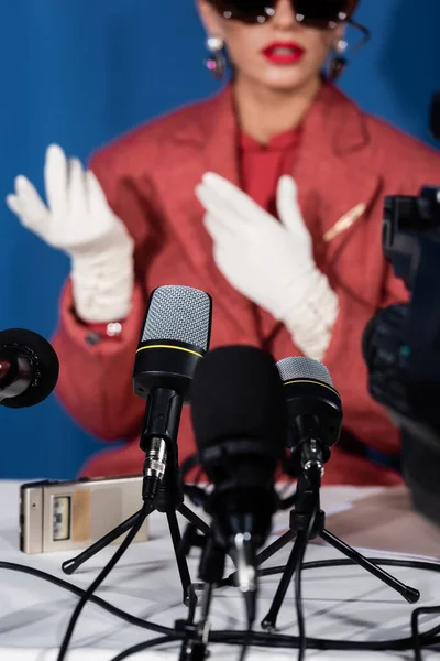 Microphones near cropped vintage style woman giving interview on blurred background — Stock Photo