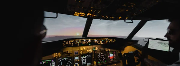 Profesionales borrosas piloteando avión en la noche durante la puesta del sol, bandera - foto de stock