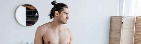 Shirtless man with long hair in modern bathroom, banner — Stock Photo