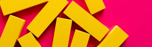 Top view of yellow rectangular blocks on pink background, banner — Stock Photo