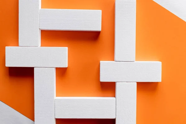 Top view of white rectangular blocks on orange background — Stock Photo