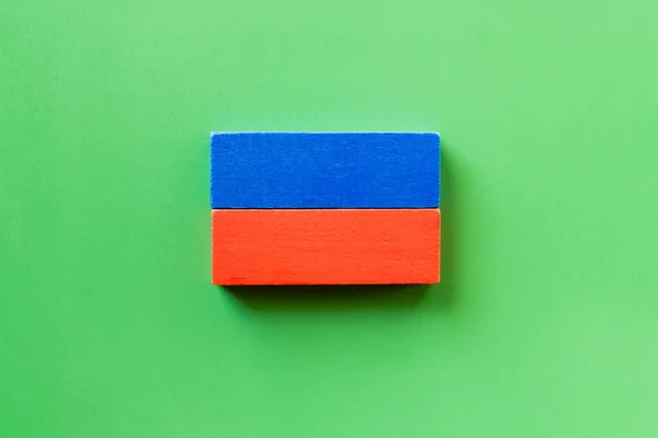 Top view of blue and red rectangular blocks on green background — Stock Photo