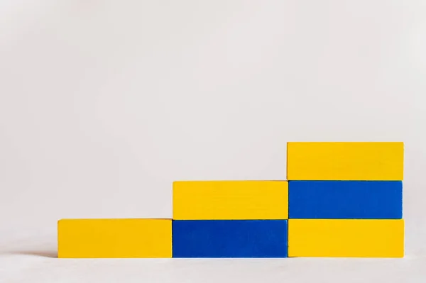 Stairs made of rectangular blue and yellow blocks on white background, ukrainian concept — Stock Photo