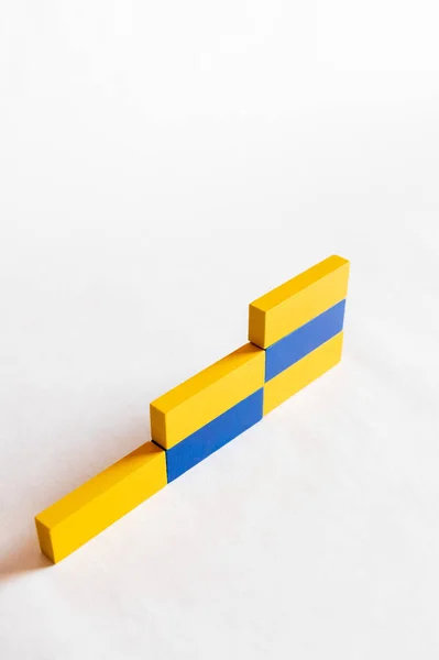 Top view of stairs made of blue and yellow blocks on white background, ukrainian concept — Stock Photo