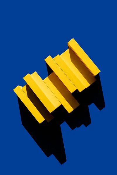 Yellow blocks on blue background with shadow, top view, ukrainian concept — Stock Photo