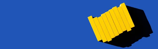 Top view of bright yellow blocks on blue background with copy space, ukrainian concept, banner — Stock Photo