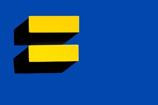 Top view of two yellow blocks on blue background, ukrainian concept — Stock Photo