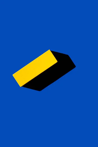 Top view of yellow rectangular block on blue background, ukrainian concept — Stock Photo