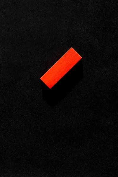 Top view of bright red block on black background with copy space — Stock Photo