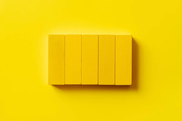 Top view of colored rectangular blocks on yellow background — Stock Photo