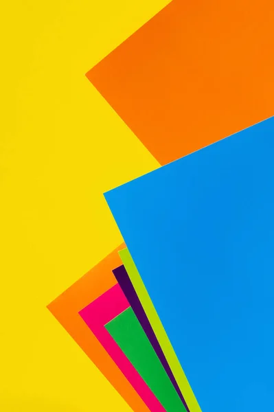 Bright geometric background with multicolored paper sheets — Stock Photo