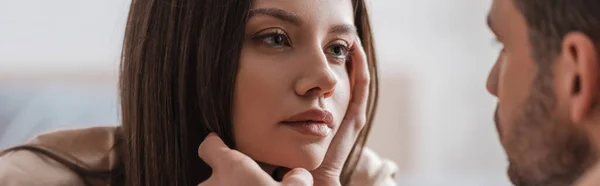 Blurred man touching face of young girlfriend at home, banner — Stock Photo