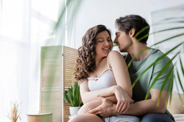 Happy man and woman hugging at home — Stock Photo