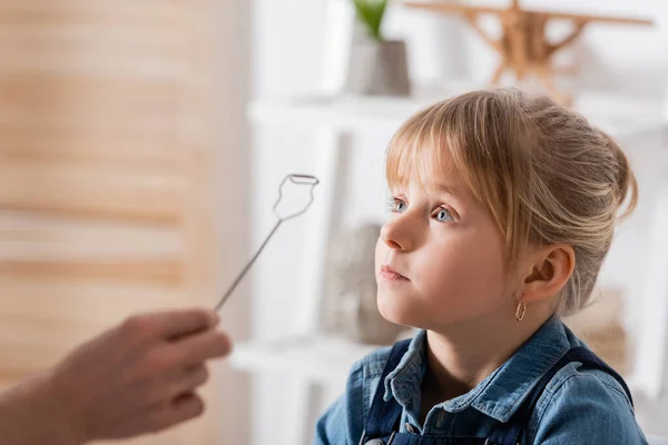 Speech therapist holding logopedic probe near pupil in classroom — Stock Photo