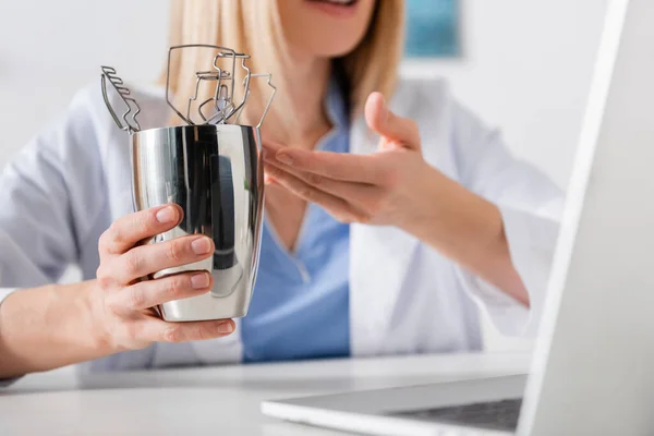 Cropped view of logopedist pointing at tools during video call on laptop — Stock Photo