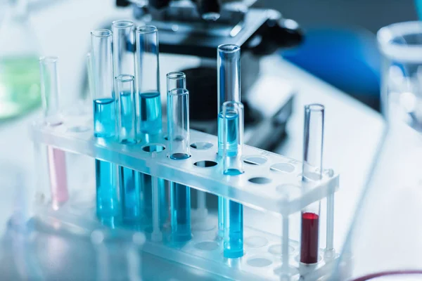 Test tubes with liquid in chemical laboratory on blurred background — Stock Photo