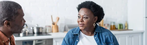 Senior african american couple talking in kitchen, banner — Stock Photo