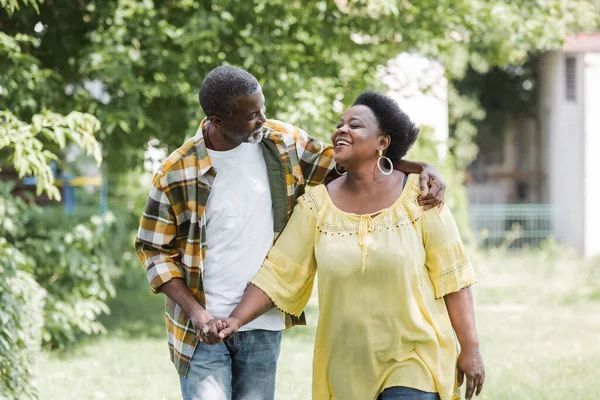 Happy senior african american couple walking in park — Stock Photo