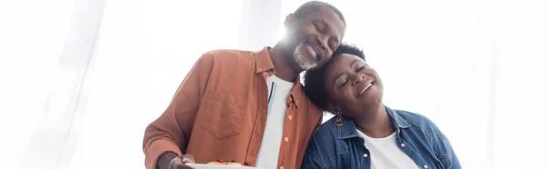 Cheerful and senior african american woman leaning on each other, banner — Stock Photo