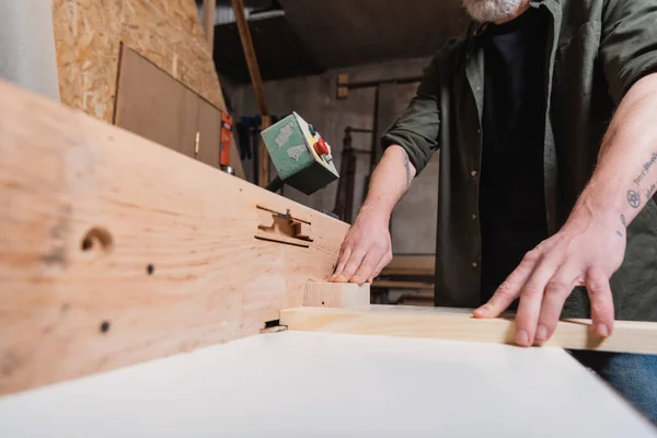 Partial view of joiner working with timber on jointer machine — Stock Photo