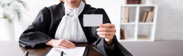 Partial view of prosecutor holding blank business card, banner — Stock Photo