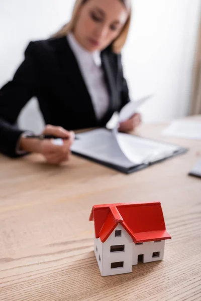 Selective focus of house model near notary on blurred background — Foto stock