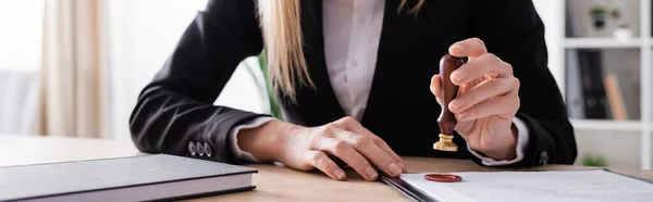 Cropped view of lawyer with stamper near notebook and contract, banner — Fotografia de Stock