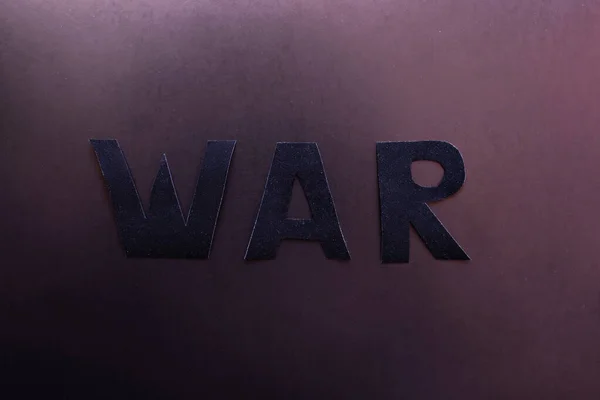 Top view of paper war lettering on dark background — Stock Photo