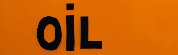 Top view of paper oil word on orange background, banner — Stock Photo