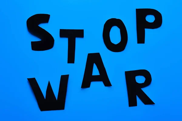 Top view of stop war lettering on blue background — Stock Photo