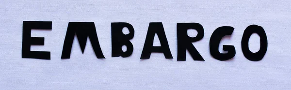 Top view of embargo lettering on white background, banner — Stock Photo