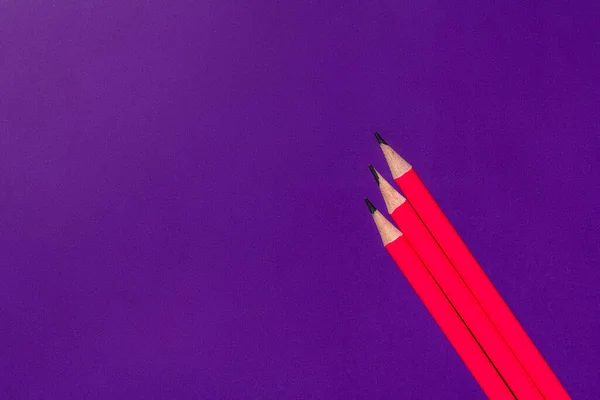 Top view of pencils on purple background — Stock Photo