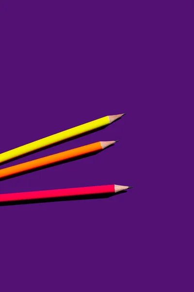 Top view of colorful pencils on purple background — Stock Photo