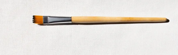 Top view of paintbrush on white canvas background, banner — Stock Photo