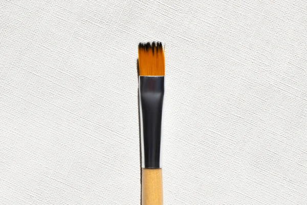 Top view of paintbrush on textured background — Stock Photo